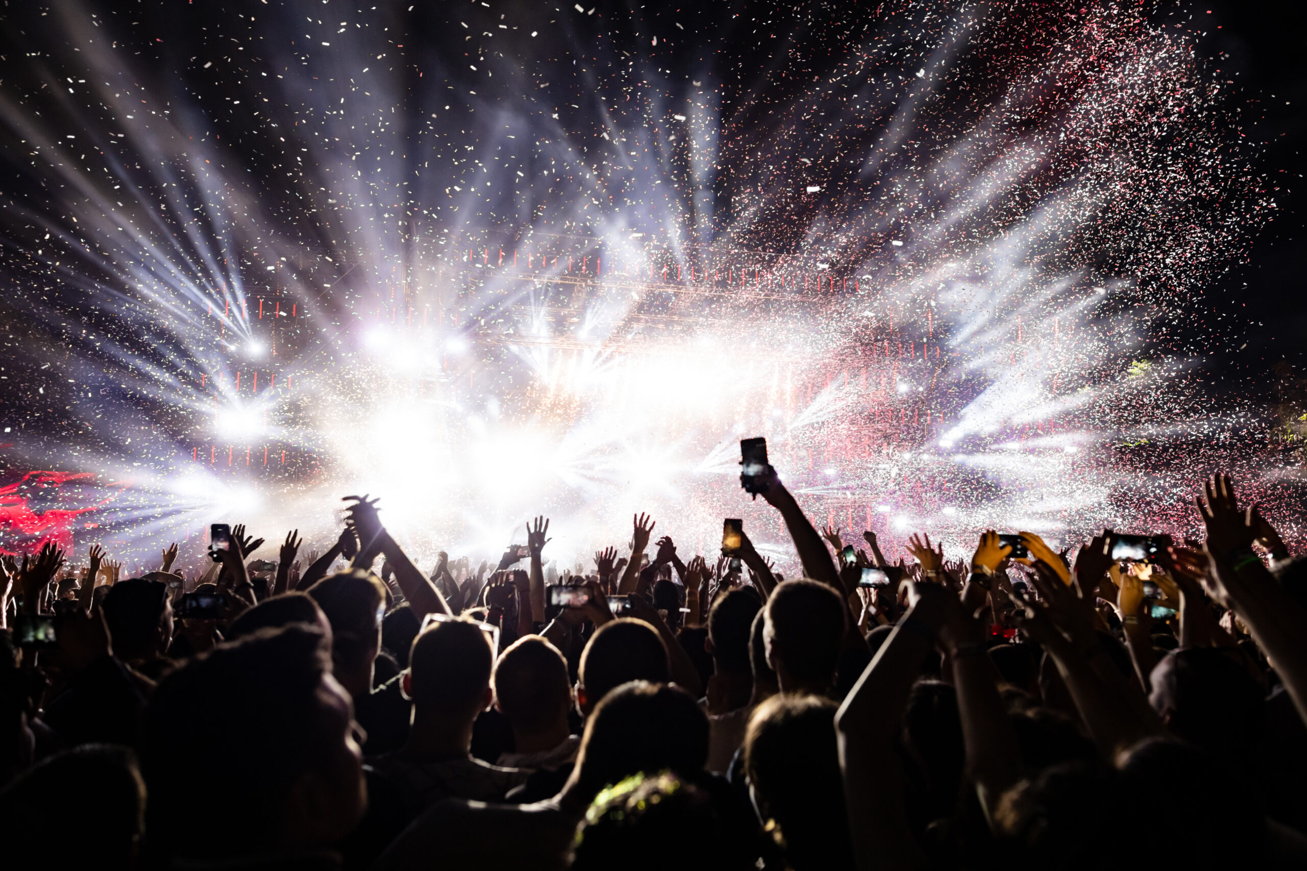 Confetti fireworks above the crowd on music festival.